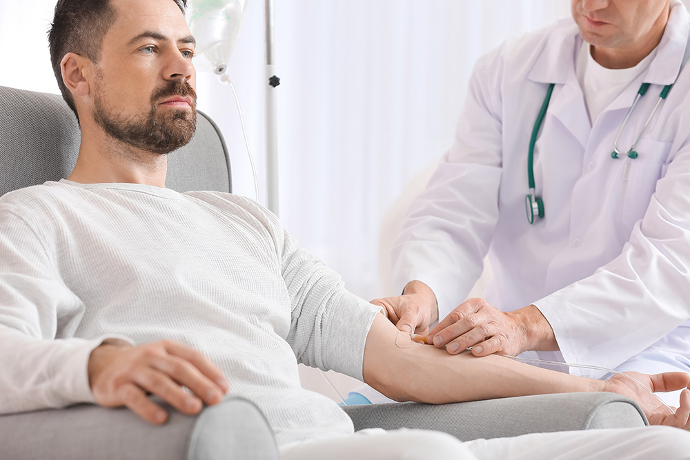 Doctor and man undergoing course of Ketamine Therapy in clinic